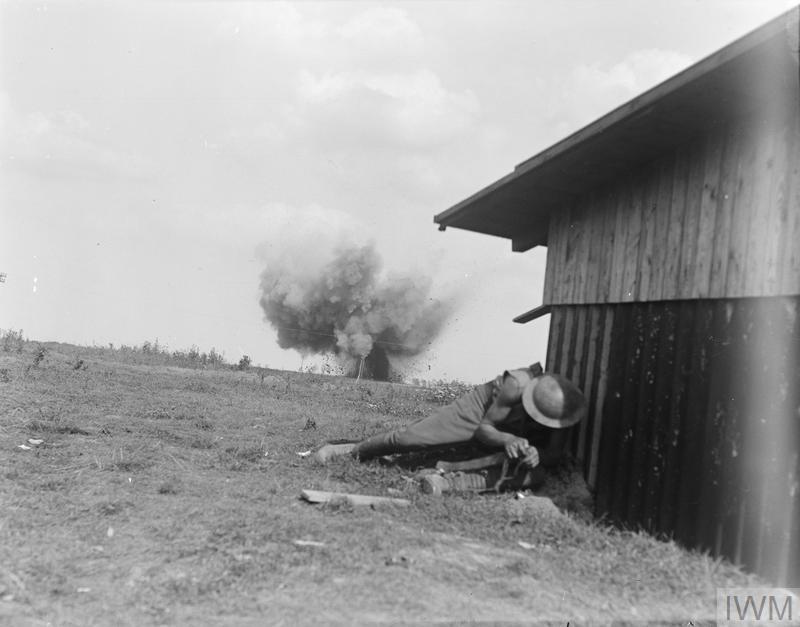 IWM (Q 11255) Soldier NZ Division takes cover as shell bursts, Grevillers, 25 Aug 1918